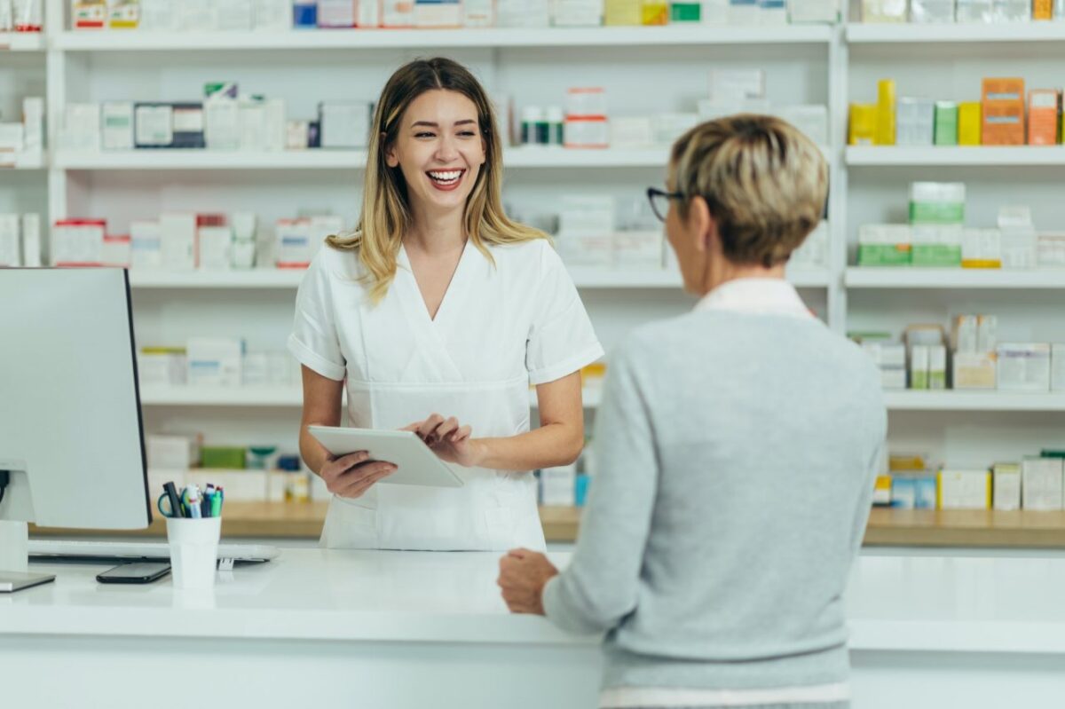 female-pharmacist-selling-medications-at-drugstore-to-a-senior-woman-customer.jpg