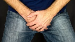 Man cover capping his hands in his lap to cover up erectile dysfunction
