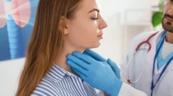 Doctor checking a females thyroid conditions
